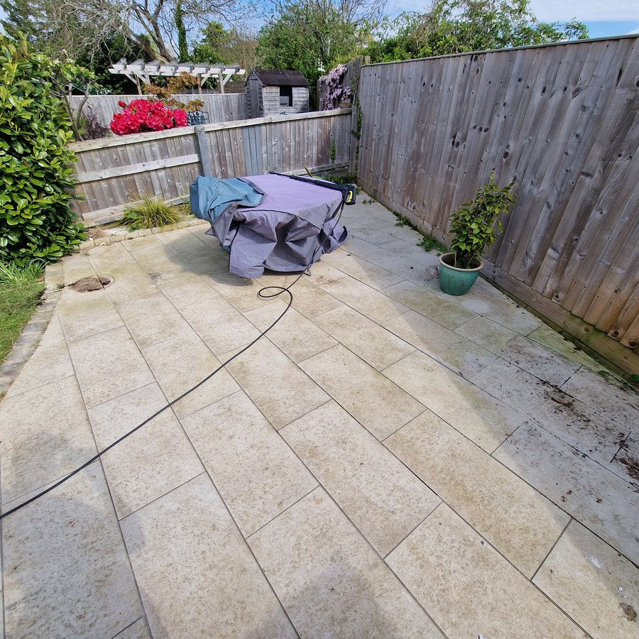 The same patio before cleaning, stained and green