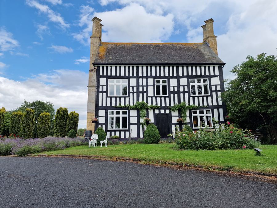 Black and white timber-framed house with clean windows