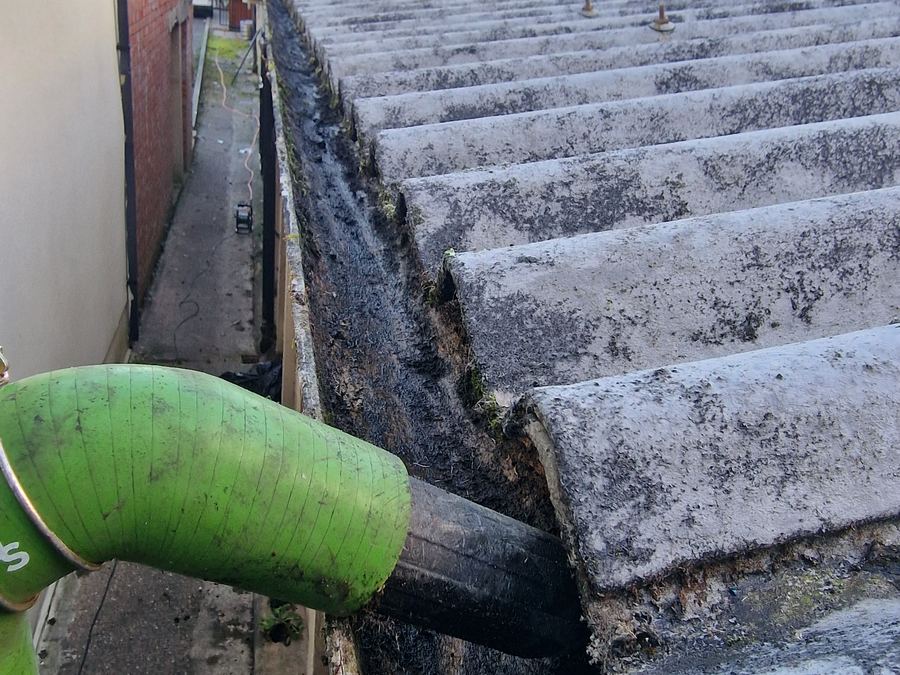 Gutter vacuum removing moss from a gutter run
