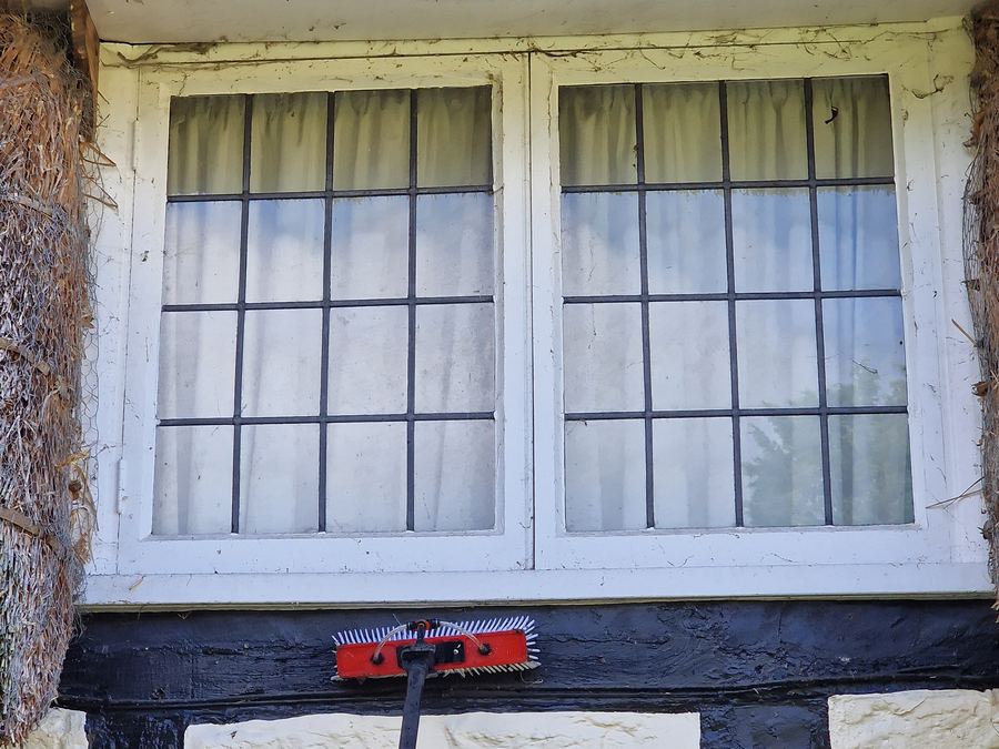 Sash windows of a thatched cottage after cleaning